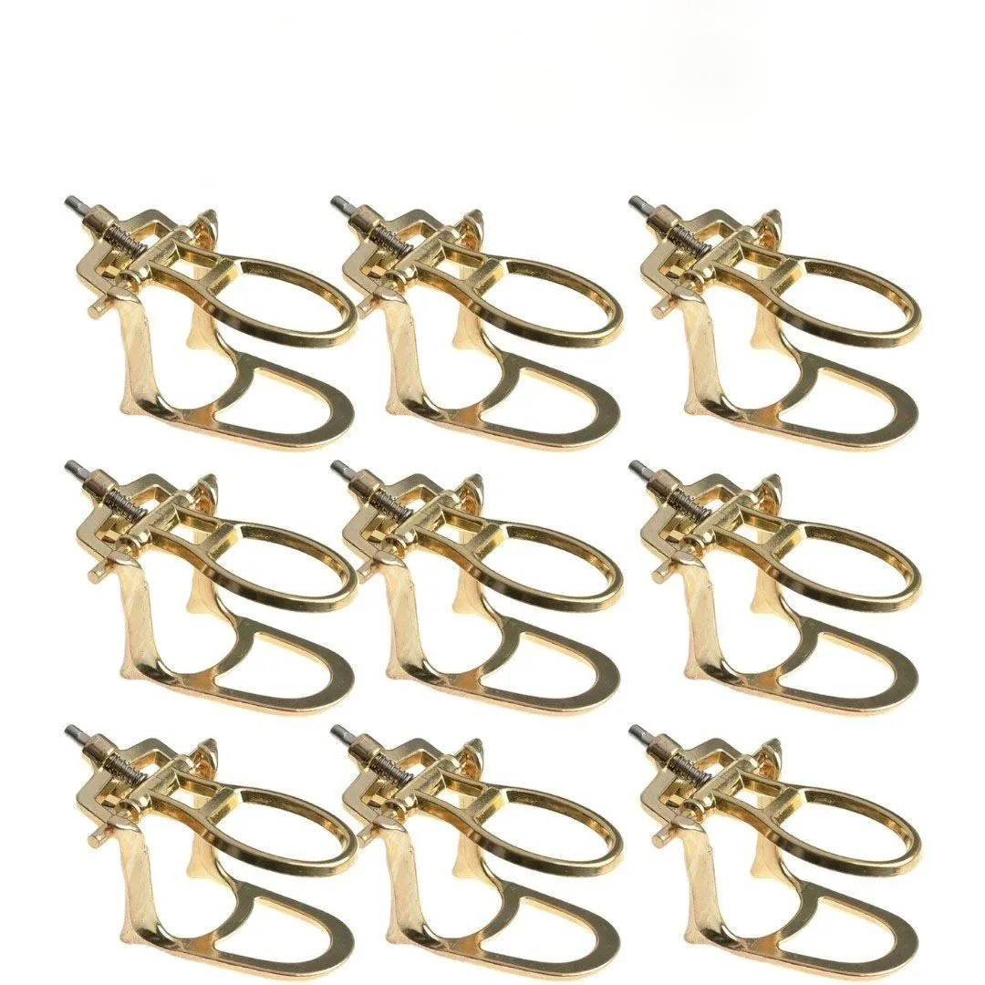 Repeated gold-coloured dental articulator frames with adjustment hardware